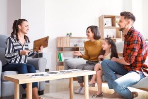 therapist talking with a family in a well lit room engaging in family therapy program