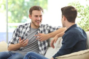 two young men discussing the benefits of attending heroin rehab
