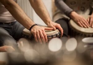 close up of a pair of hands holding a drum in a music therapy program for addiction recovery
