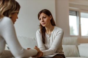 a patient talks to a therapist in a trauma therapy program