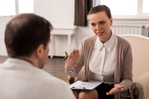 a person talks with a therapist during rational emotive behavior therapy