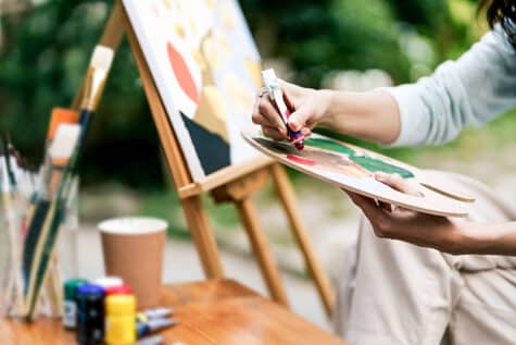 A person participates in art therapy, a form of experiential therapy.