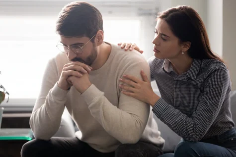 A woman helps her partner in recovery.
